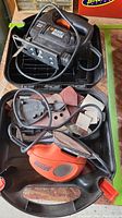 Black & Decker jig saw in black with power cord and case compartments.