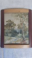 Full view of the framed watercolour painting depicting trees and a stream.