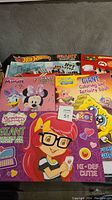 Six kids giant colouring and activity books with various popular characters visible on covers