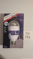 Front view of Spirals Lightshow LED bulb in packaging showing product name, fitting info and LED feature.