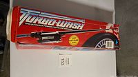 The original Turbo Wash box with graphic branding and image of pressure washer with tire,