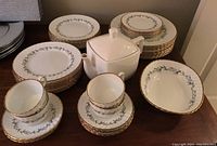 Full set of Adderley fine bone china dishes arranged including dinner plates, side plates, bowls, tea cups, saucers, and a white square modern teapot.