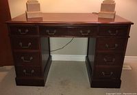 Front view showing eight drawers and brass hanging pulls