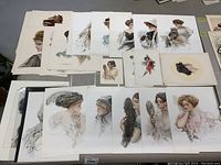 Collection of vintage Howard Christy and Harrison Fisher ladies prints displayed together showing various women portraits in period dress.