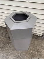 Front angled view of grey hexagonal Esso station garbage can showing the wide top opening and condition.