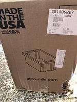 Photo of the sealed cardboard box showing Akro-Mils branding, model 35180 grey color label, and Made in the USA printing.