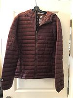 Front view of men's burgundy ultra light jacket with full zip and thumb holes on sleeves.
