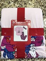 Packaged pajama set with label showing product and cat design.