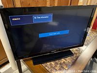 Front view of the TV powered on showing HDMI/DVI no signal screen.