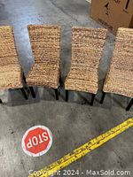 Set of 4 wicker chairs positioned side by side, showing full view of seats and backs