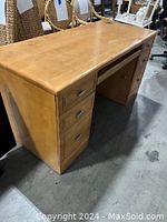Wooden desk with multiple drawers and smooth natural finish