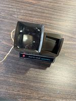 Top view of one Pana Vue Automatic slide viewer showing the magnifier lens and slide insertion slot.