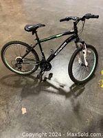 Side profile view of the black Schwinn mountain bike showing frame, tires, saddle, and drivetrain.