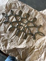 Full view of the metal coat hanger showing the loop design and overall shape.