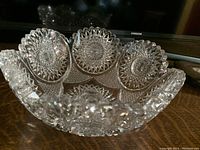 Top side angle showing intricate hobnail cut glass pattern with starburst central motif and scalloped rim.