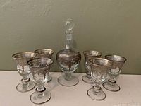 Full set of six sherry glasses and decanter with gold pattern