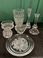 Seven crystal items including tall vase, candlesticks, votive holders, footed bowl and orchid intaglio plate.
