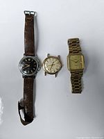 Three watches laid out: Zentra, Bulova, Elgin