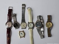 Full lot image showing 7 assorted watches including leather and metal bands, various dial colors and styles.
