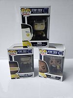 Front view of three boxed Funko Pop vinyl figures from Star Trek The Next Generation - Data, Geordi La Forge, and Worf.
