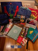 Full view of the arts and crafts supplies, showing Lego bag, backpacks, art paper, crayons, chalk, game box, and scissors.