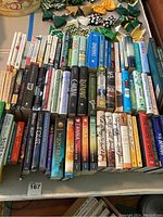 Wide view of multiple rows of books, showing mostly YA novels and some nonfiction titles like anatomy and oceanology.