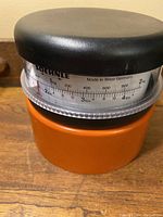 Front side view of the orange and black Soehnle kitchen scale showing measurement dial labeled in kg and lbs, Made in West Germany.
