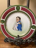 Full view of the collectible plate with color and pattern visible, showing Napoleon portrait and ornate rim.