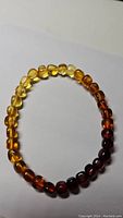 Polished Baltic amber bracelet with beads in varying tones of yellow to brown.