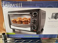 Bravetti toaster oven in original blue box showing unit with muffins inside and control knobs, highlighting toaster oven design and branding.