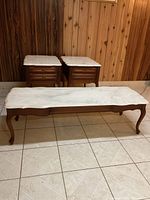 Overview of all three tables: one coffee table in front and two side tables behind with marble tops and wood frames.