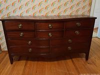 Front full view of the dresser showing all six drawers and brass oval pull handles.