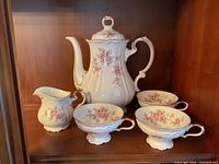 Full view of Edelstein fine china tea set including teapot, creamer, two teacups