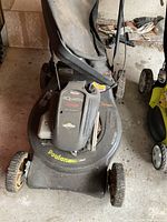 Full view of Poulan Quattro 4HP gas lawnmower showing engine and deck.