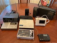 Overview of all six items: scanner, portable radios, clock radio and boxed travel radio