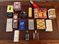 Top-down view of all perfume bottles and boxes on a wooden surface, showing brand names and packaging styles.