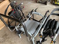Group view of three mobility devices: two rollator walkers and one transport wheelchair
