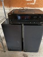 Sony STR-D990 receiver on top of two JBL speakers, all black with visible signs of use.
