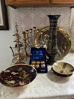 Wide view showing all items including platter, candlesticks, vase, bowls, and napkin rings.