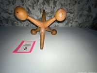 Top view of the cast iron jack bookend showing the four interlocking arms and rounded ends.