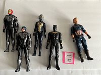 Photo showing five large toy action figures on a white background including Iron Man, Captain America, Ant-Man, Black Panther, and another Captain America figure.
