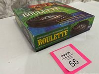 Photo of the game box showing the roulette wheel side and branding on the box including details of the wheel size and features