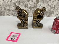 Pair of antique Patinated Bronze Finish Rodin's The Thinker Bookends shown side by side with a soda can for scale.