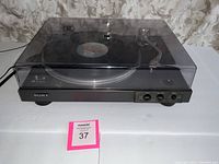Full front view of the Sony turntable with dust cover closed, showing brand logo and front controls.