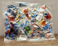 Three sealed plastic bags each containing 12 colorful bendable sticky gooey toy figures, displaying the lot's content clearly.