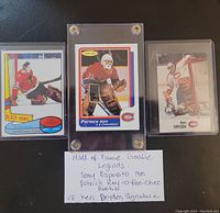 Front view of three cards: Tony Esposito (left), Patrick Roy (center), Ken Dryden (right) plus handwritten lot note