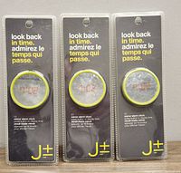 Front view of 3 mirror LED alarm clocks in blister packaging showing reflective faces and time display.