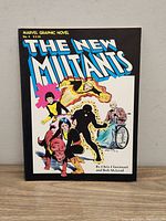 Front cover of Marvel Graphic Novel No. 4 The New Mutants comic book showing title and artwork of characters.