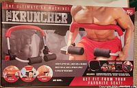 Box of The Kruncher AB Machine showing branding, features, and uses targeting upper abs, lower abs, and obliques.