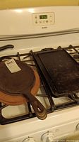 Photo of rectangular cast iron griddle on stove top showing surface and handles